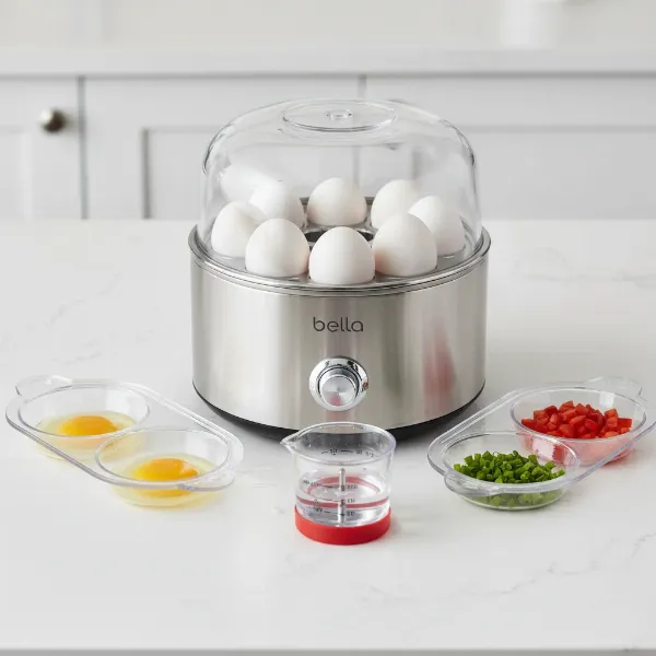 Close-up of Bella Rapid electric egg cooker with trays and measuring cup on a kitchen counter.