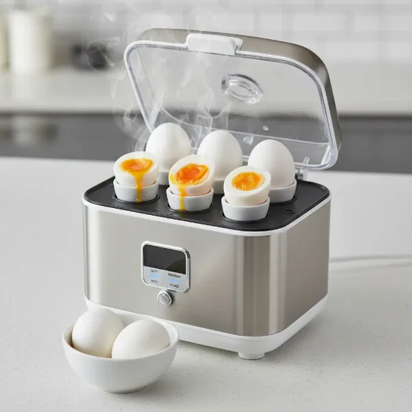 A sleek electric egg cooker with various doneness levels of eggs: soft, medium, hard boiled.