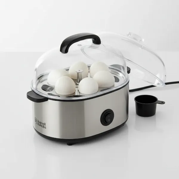 Russell Hobbs egg cooker showing its capacity for 7 eggs, transparent lid, and stainless steel finish.